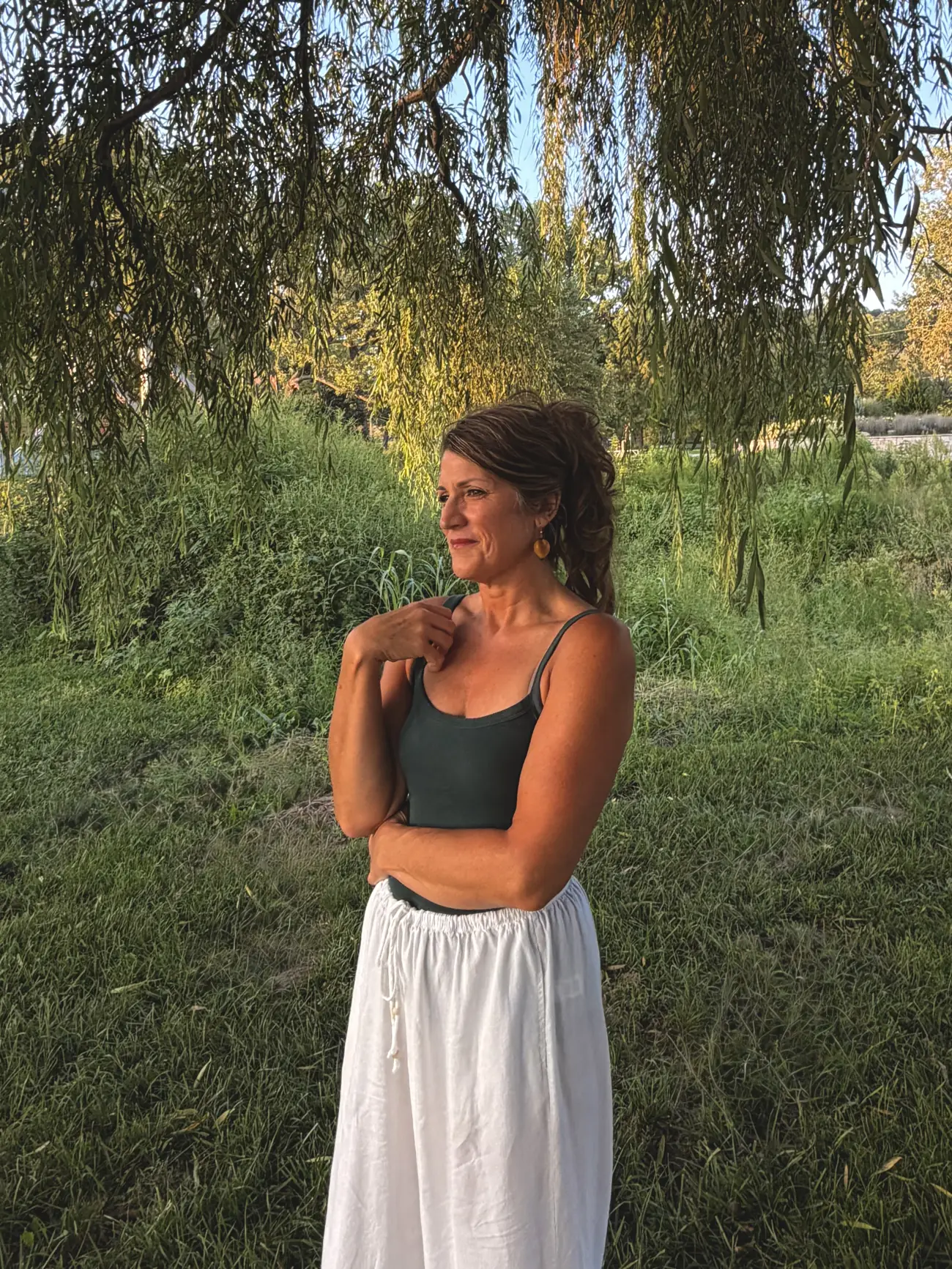 Teresa Nerem of Soul Balm Massage Therapy standing under a willow tree